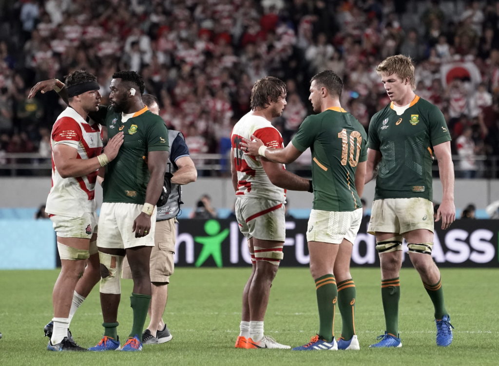 Japanese and South African players interact after the game