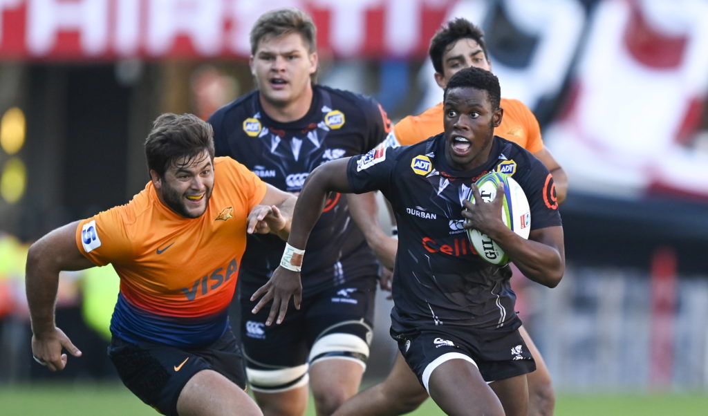 Aphelele Fassi (R) of the Sharks drives the ball during the Super Rugby match between Sharks and Jaguares at the Jonsson Kings Park, Durban