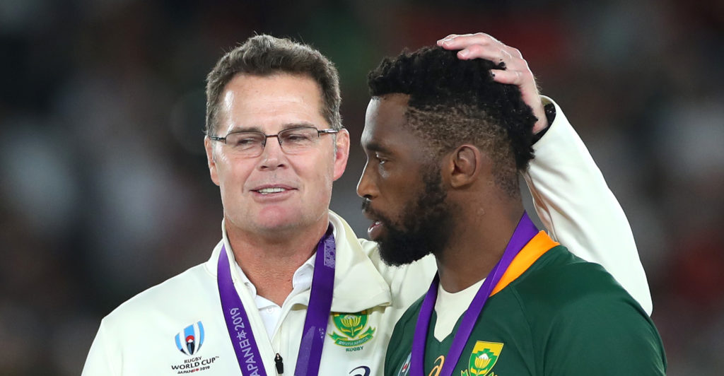 Springboks coach Rassie Erasmus, Head Coach of South Africa talks to Siya Kolisi of South Africa after victory in the Rugby World Cup 2019 Final between England and South Africa at International Stadium Yokohama on November 02, 2019