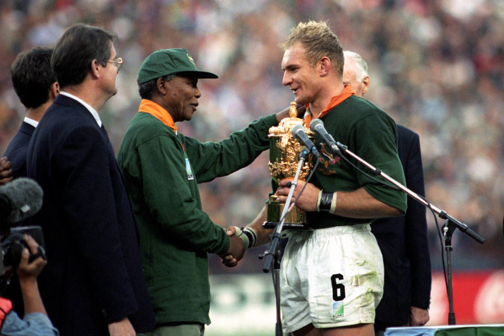 Francois Pienaar receives the World Cup from Nelson Mandela