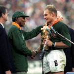 Francois Pienaar receives the World Cup from Nelson Mandela
