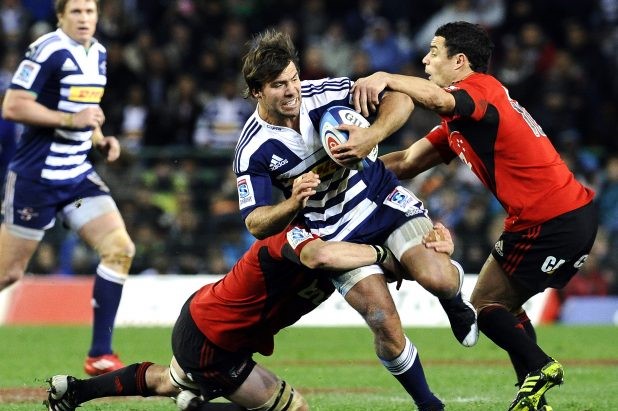 Dan Carter tackles Schalk Brits in Super Rugby