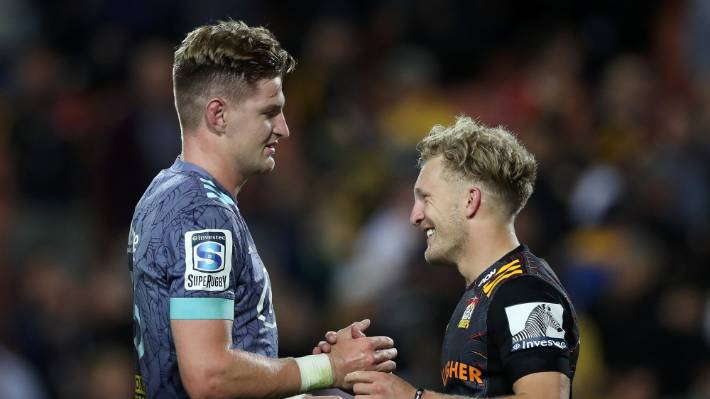 Jordie Barrett of the Hurricanes is congratulated by Damian McKenzie of the Chiefs after winning the round seven Super Rugby match between the Chiefs and the Hurricanes at Waikato Stadium on March 13, 2020 in Hamilton, New Zealand. (Photo by Hannah Peters/Getty Images)