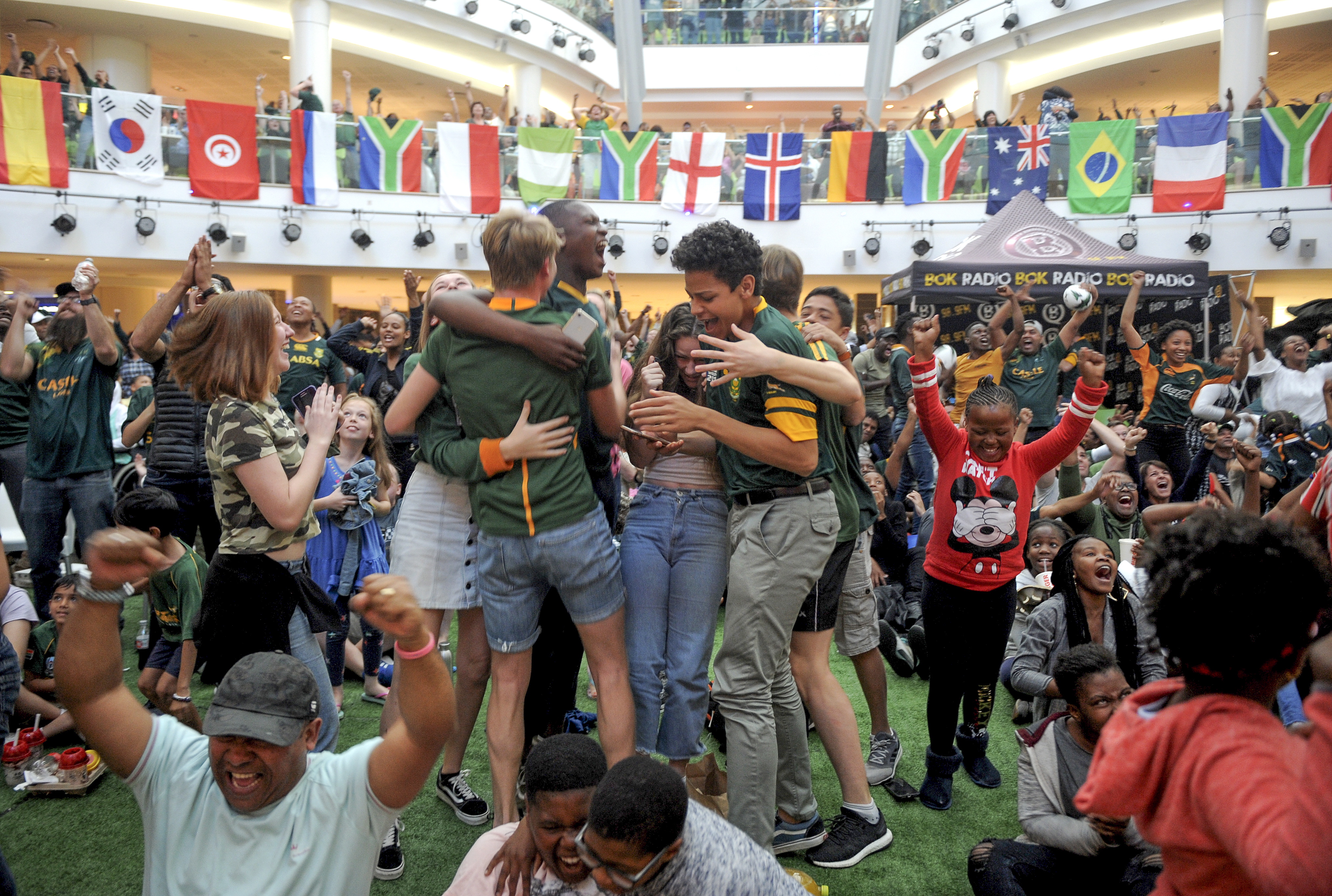 epa07966828 South African fans celebrate winning the rugby World Cup final between England and South Africa played in Japan, at a big screen broadcast in Tygervalley Mall, Cape Town, South Africa, 02 November 2019. South Africa beat England 32-12. EPA/STR