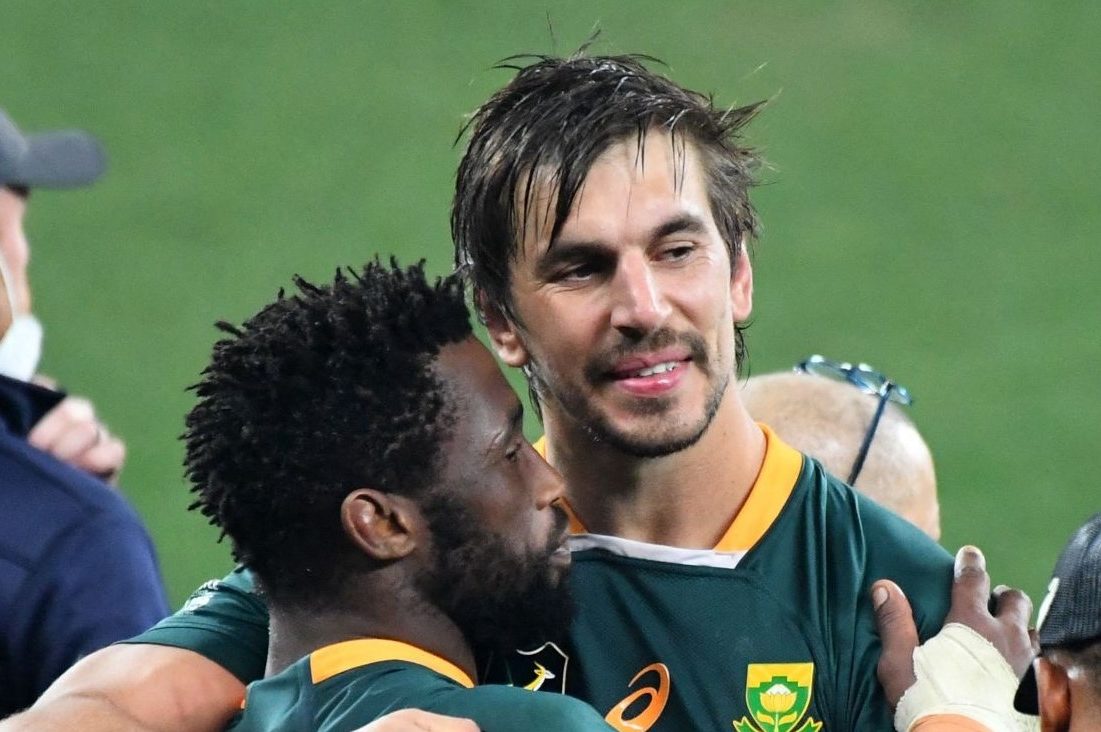 South Africa's lock Eben Etzebeth (R) and South Africa's blindside flanker and captain Siya Kolisi celebrate after victory with teammates in the third rugby union Test match between South Africa and the British and Irish Lions at The Cape Town Stadium in Cape Town on August 7, 2021. (Photo by RODGER BOSCH / AFP) (Photo by RODGER BOSCH/AFP via Getty Images)