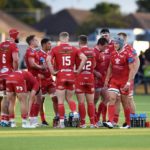The Scarlets in a huddle