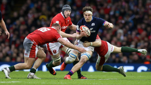 CARDIFF, WALES - FEBRUARY 12: Scotland's Rory Darge (centre) is tackled by Wales' Dan Biggar and Dewi Lake during a Guiness Six nations match between Wales and Scotland at the Principality Stadium, on February 12, 2022, in Cardiff, Wales.