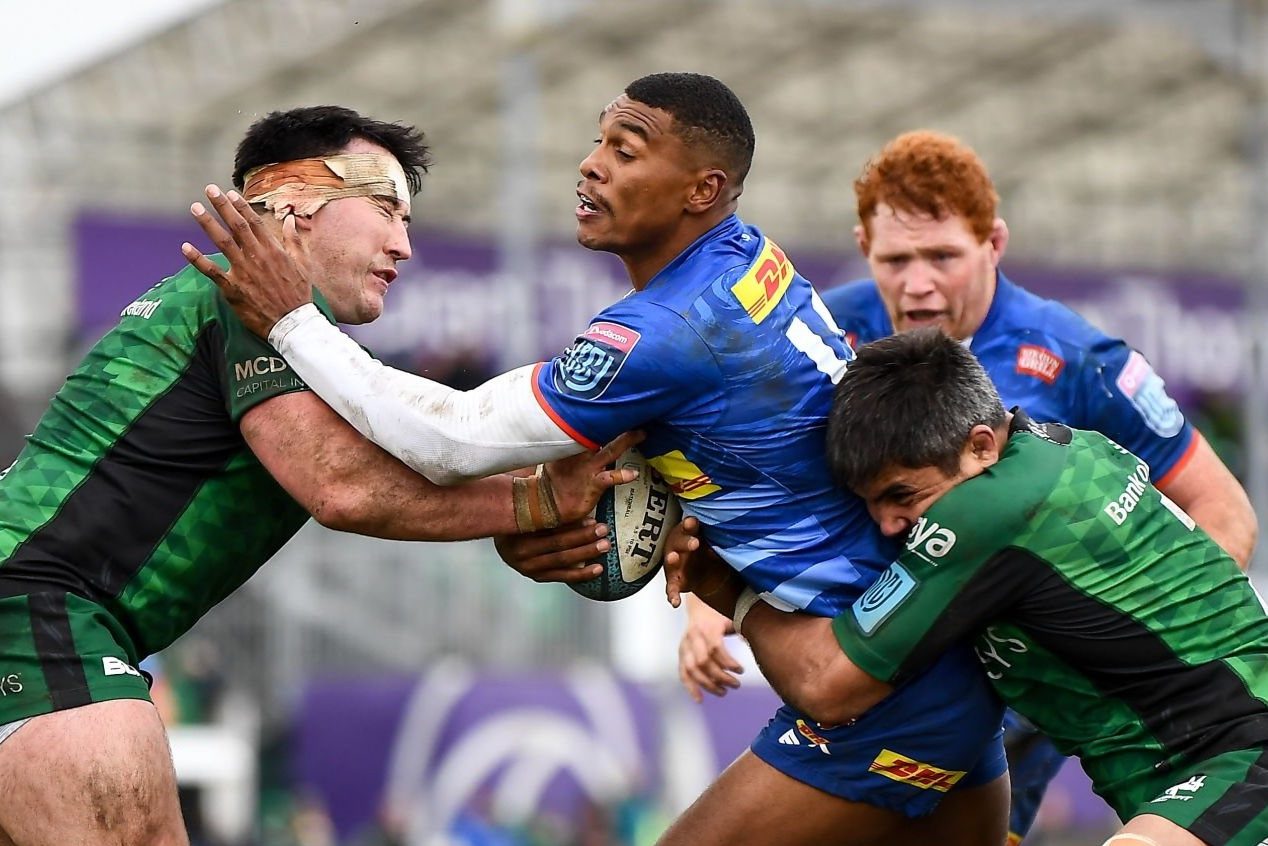 Galway , Ireland - 26 February 2022; Damian Willemse of DHL Stormers evades the tackle of Denis Buckley, left, and Jarrad Butler of Connacht on his way to scoring his side's second try during the United Rugby Championship match between Connacht and DHL Stormers at The Sportsground in Galway. (Photo By Harry Murphy/Sportsfile via Getty Images)