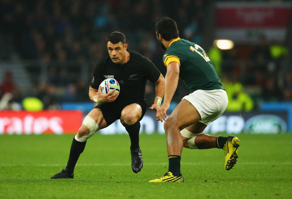 LONDON, ENGLAND - OCTOBER 24: Dan Carter of the New Zealand All Blacks takes on Damian De Allende of South Africa during the 2015 Rugby World Cup Semi Final match between South Africa and New Zealand at Twickenham Stadium on October 24, 2015 in London, United Kingdom.