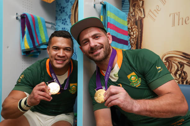 TOKYO, JAPAN - NOVEMBER 02: Willie Le Roux and Cheslin Kolbe of South Africa with the gold medals at the changing room after the Rugby World Cup 2019 Final match between England and South Africa at International Stadium Yokohama on November 02, 2019 in Tokyo, Japan.