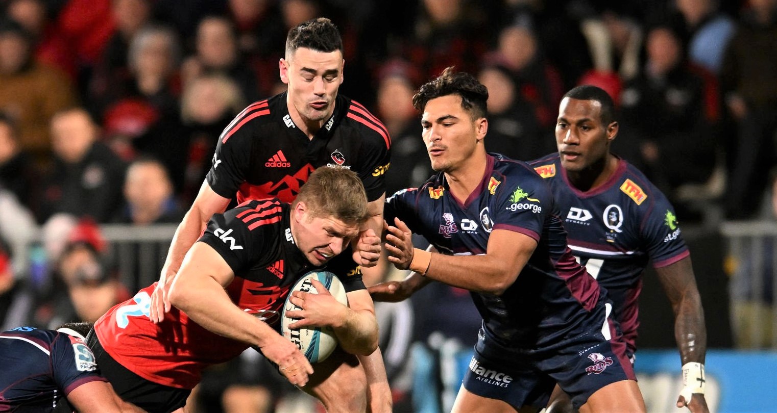 CHRISTCHURCH, NEW ZEALAND - JUNE 03: Jack Goodhue of the Crusaders gets tackled by the defence during the Super Rugby Pacific Quarter Final match between the Crusaders and the Queensland Reds at Orangetheory Stadium on June 03, 2022 in Christchurch, New Zealand. (Photo by Joe Allison/Getty Images)