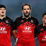 AUCKLAND, NEW ZEALAND - JUNE 18: L to R, Scott Barrett, Sam Whitelock, and Codie Taylor of the Crusaders sing the national anthem during the 2022 Super Rugby Pacific Final match between the Blues and the Crusaders at Eden Park on June 18, 2022 in Auckland, New Zealand.