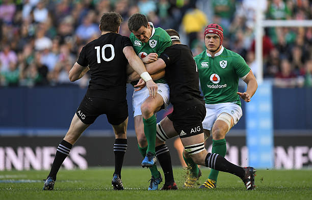 Illinois , United States - 5 November 2016; Jonathan Sexton of Ireland is tackled by Beauden Barrett, left, and Sam Cane of New Zealand during the International rugby match between Ireland and New Zealand at Soldier Field in Chicago, USA.