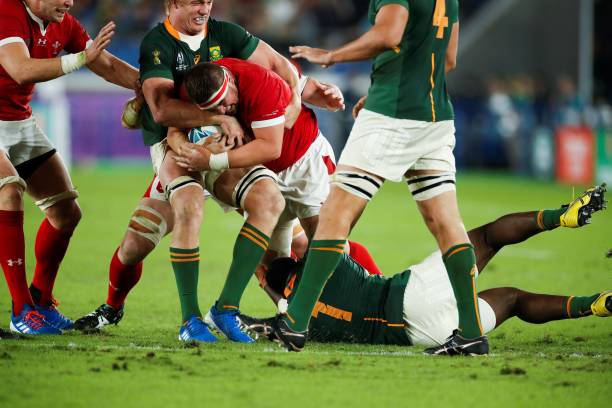 South Africa's flanker Pieter-Steph Du Toit (2nd L) tackles Wales' prop Wyn Jones (C) during the Japan 2019 Rugby World Cup semi-final match between Wales and South Africa at the International Stadium Yokohama in Yokohama on October 27, 2019.