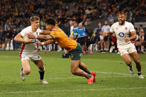 PERTH, AUSTRALIA - JULY 02: Jack van Poortvliet of England fends off Jordan Petaia of the Wallabies while running in for a try during game one of the international test match series between the Australian Wallabies and England at Optus Stadium on July 02, 2022 in Perth, Australia.