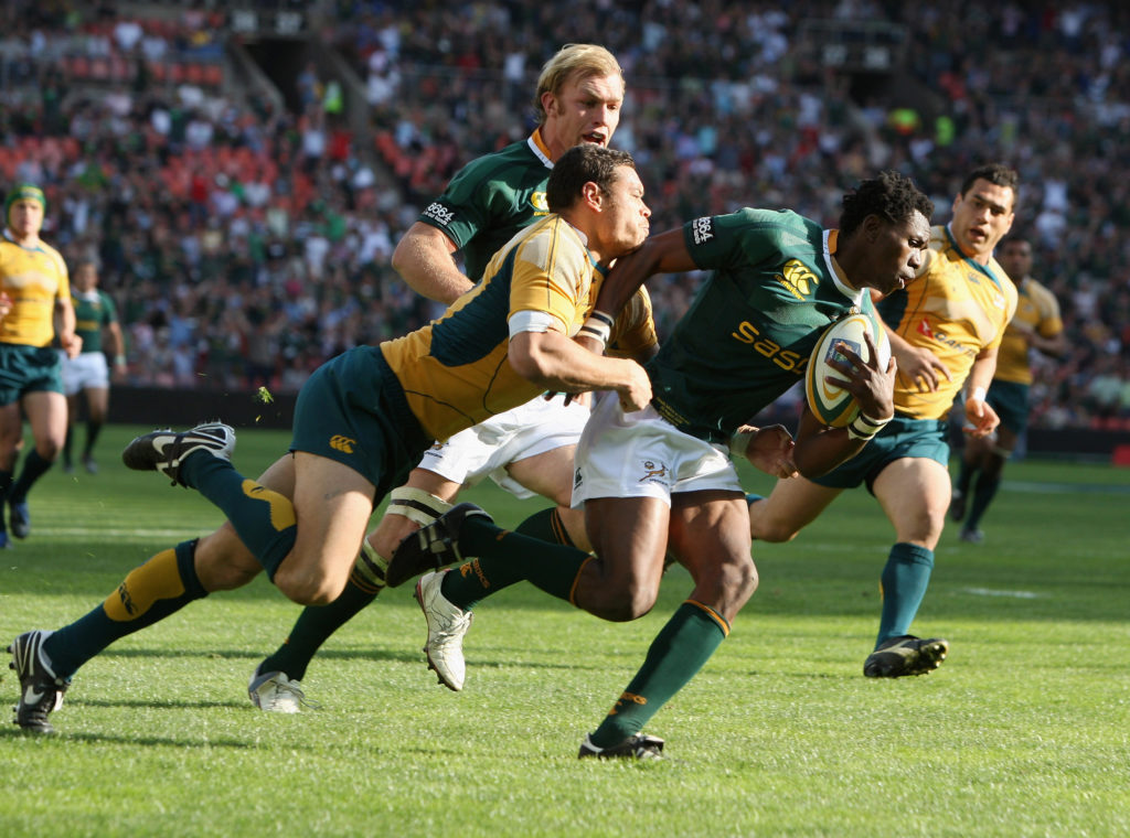 JOHANNESBURG, SOUTH AFRICA - AUGUST 30: Jongi Nokwe of South Africa dives over to score his fourth try of the match despite being tackled by Timana Tahu of Australia during the 2008 Tri Nations match between the South Africa Springboks and the Australian Wallabies held at Ellis Park on August 30, 2008 in Johannesburg, South Africa.