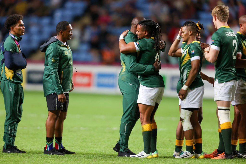COVENTRY, ENGLAND - JULY 31: Selvyn Davids of South Africa and fellow players hug each other after winning the gold medal during the Rugby Sevens final match between South Africa and Fiji on day 3 of the 2022 Commonwealth Games at Coventry Stadium on July 31, 2022 in Coventry, England.