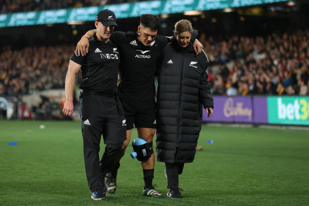 MELBOURNE, AUSTRALIA - SEPTEMBER 15: Quinn Tupaea of the All Blacks is assisted from the field after sustaining a injury during The Rugby Championship & Bledisloe Cup match between the Australia Wallabies and the New Zealand All Blacks at Marvel Stadium on September 15, 2022 in Melbourne, Australia.