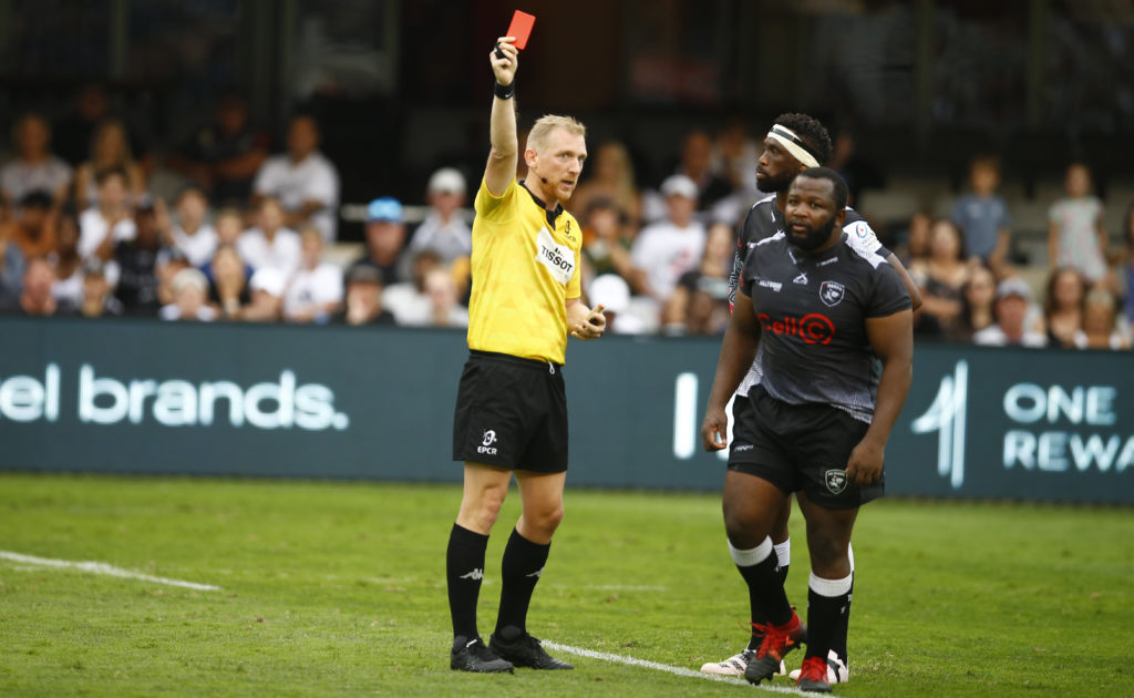 DURBAN, SOUTH AFRICA - DECEMBER 10: Referee:Tual Trainini and Ox Nche of the Cell C Sharks during the Heineken Champions Cup match between Cell C Sharks and Harlequins at Hollywoodbets Kings Park on December 10, 2022 in Durban, South Africa.