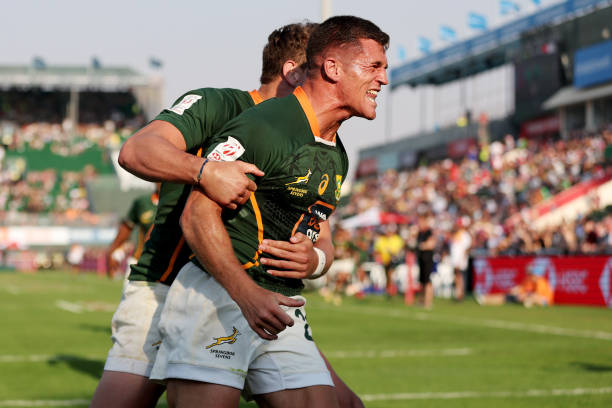 DUBAI, UNITED ARAB EMIRATES - DECEMBER 02: Ricardo Duarttee of South Africa celebrates scoring a try with teammate James Murphy during the match between South Africa and Kenya on day one of the HSBC World Rugby Sevens Series - Dubai at The Sevens Stadium on December 02, 2022 in Dubai, United Arab Emirates.