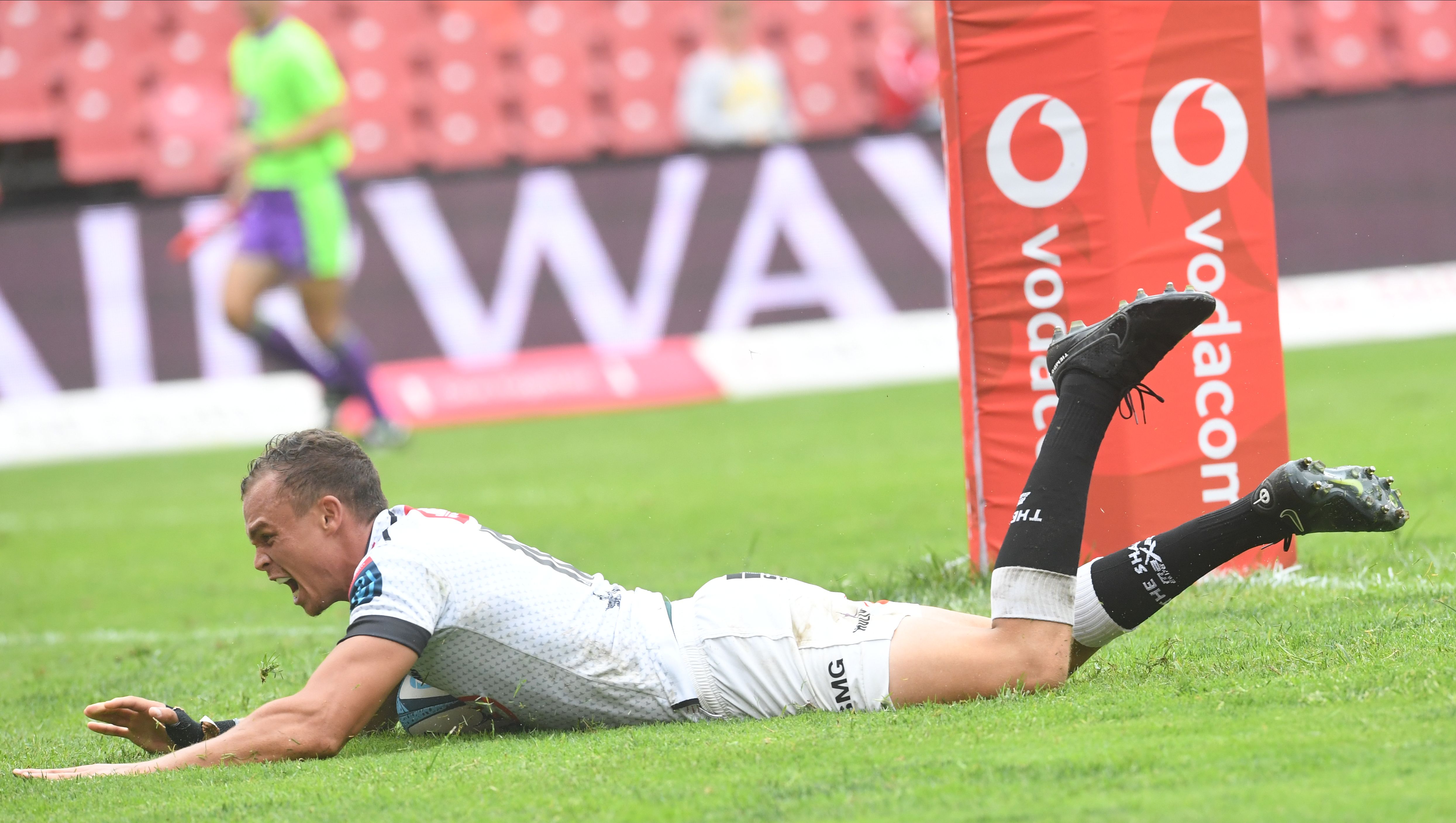 JOHANNESBURG, SOUTH AFRICA - FEBRUARY 18: Curwin Bosch of the Sharks breaks away from the Lions defence, score a try and celebrate with teammates during the United Rugby Championship match between Emirates Lions and Cell C Sharks at Emirates Airline Park on February 18, 2023 in Johannesburg, South Africa.