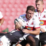Tiaan Swanepoel of the Lions tackled by Yaw Penze of the Sharks during the 2023 Currie Cup match between Lions and Sharks at the Emirates Airline Park, Johannesburg on the 01 April 2023 ©Muzi Ntombela/BackpagePix