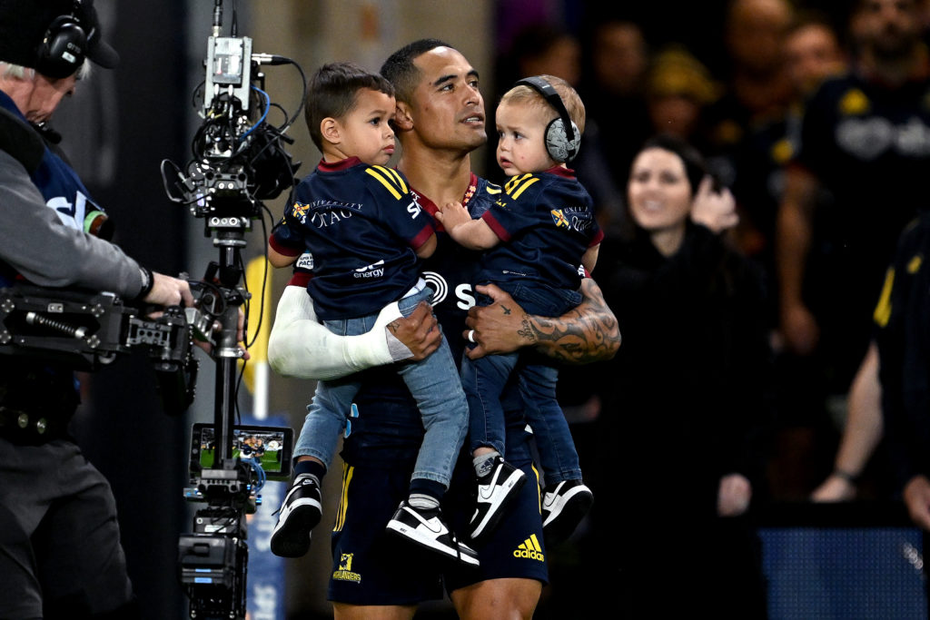 DUNEDIN, NEW ZEALAND - MAY 26: Aaron Smith of the Highlanders takes to the field with his children during the round 14 Super Rugby Pacific match between Highlanders and Queensland Reds at Forsyth Barr Stadium, on May 26, 2023, in Dunedin, New Zealand.