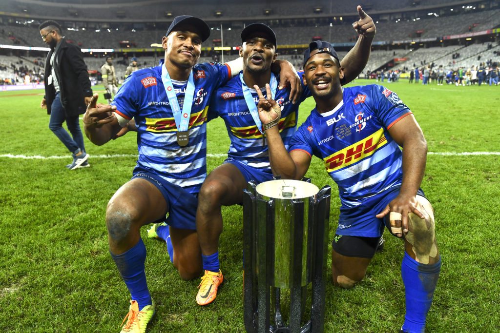 CAPE TOWN, SOUTH AFRICA - JUNE 18: Damian Willemse, Warrick Gelant and Sergeal Petersen of the Stormers pose with the trophy during the United Rugby Championship final match between DHL Stormers and Vodacom Bulls at DHL Stadium on June 18, 2022 in Cape Town, South Africa.