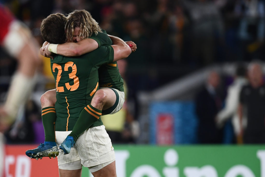 South Africa's centre Frans Steyn hugs South Africa's scrum-half Faf de Klerk (R) after winning the Japan 2019 Rugby World Cup semi-final match between Wales and South Africa at the International Stadium Yokohama in Yokohama on October 27, 2019.
