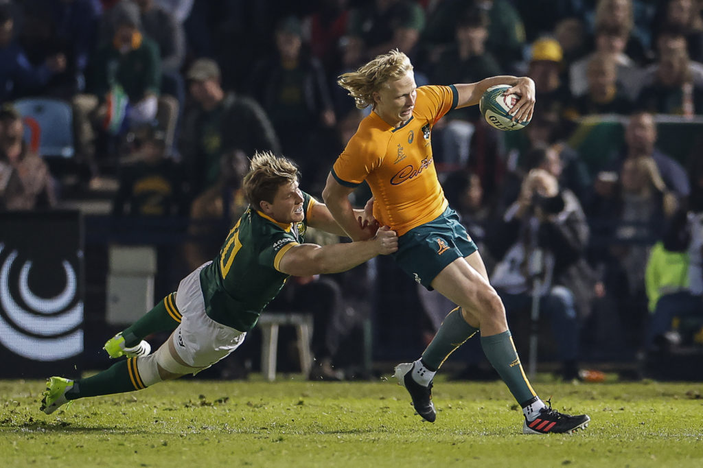 Australia's fly-half Carter Gordon (R) is tackled by South Africa's back row Evan Roos during the Rugby Championship first round match between South Africa and Australia at Loftus Versfeld stadium in Pretoria on July 8, 2023.
