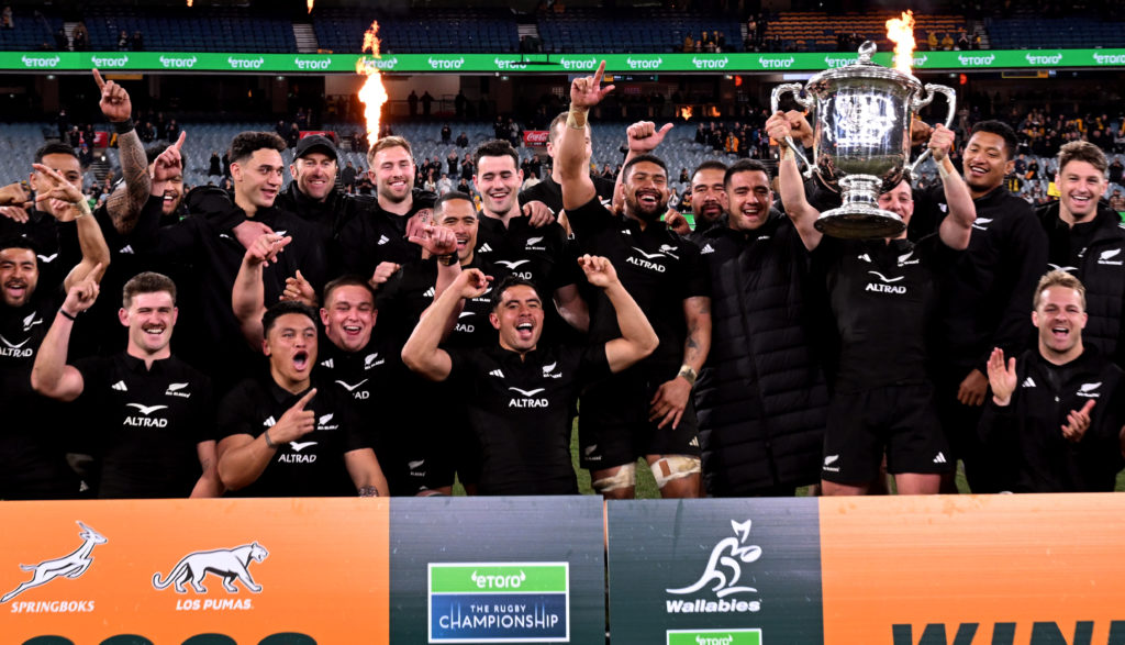 New Zealand's Cam Roigard (C) holds the trophy after the Rugby Championship 2023 and Bledisloe Cup Test match between Australia and New Zealand at the MCG in Melbourne on July 29, 2023.