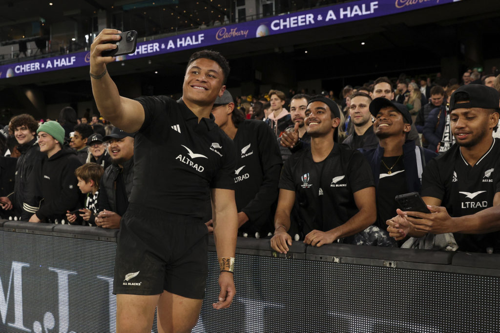 New Zealand's Caleb Clarke poses for a selfie with fans during the Rugby Championship and 2023 Bledisloe Cup match between Australia and New Zealand at Melbourne Cricket Ground in Melbourne on July 29, 2023.