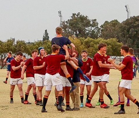 Grey College's flyhalf celebrates with Paul Roos