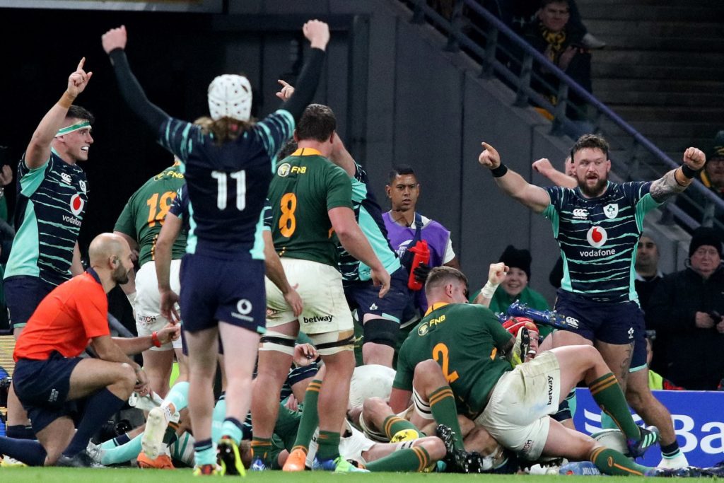 Irish players celebrates after Ireland's flanker Josh van der Flier (red cap, 3rd right) scores their first try during the Autumn International friendly rugby union match between Ireland and South Africa at the Aviva Stadium in Dublin, on November 5, 2022. (