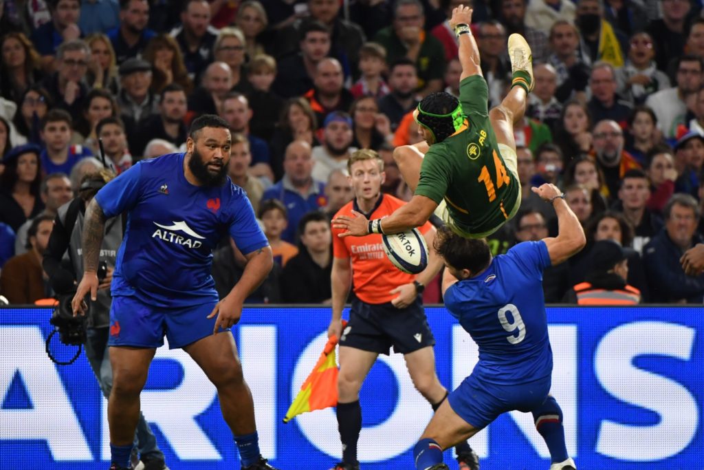 South Africa's wing Cheslin Kolbe (Top) is fooled by France's scrum-half Antoine Dupont (R) during the Autumn Nations Series rugby union test match between France and South Africa at the Velodrome stadium in Marseille on November 12, 2022