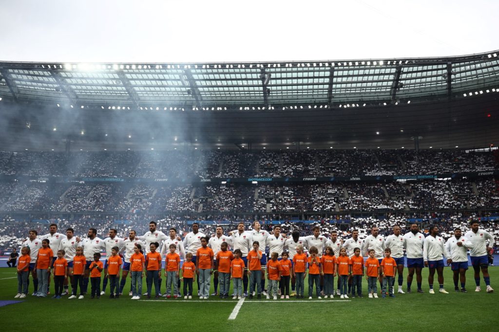 France's scrum-half Antoine Dupont (L) leads his players in the national anthem ahead of the pre-World Cup rugby union international Test match between France and Australia at Stade de France in Saint Denis, on the outskirts of Paris on August 27, 2023.