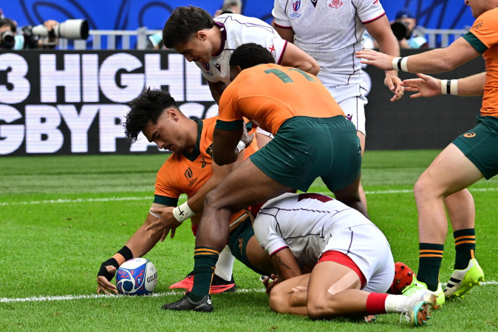 Australia's outside centre Jordan Petaia (L) scores a try during the France 2023 Rugby World Cup Pool C match between Australia and Georgia at Stade de France in Saint-Denis, on the outskirts of Paris, on September 9, 2023.
