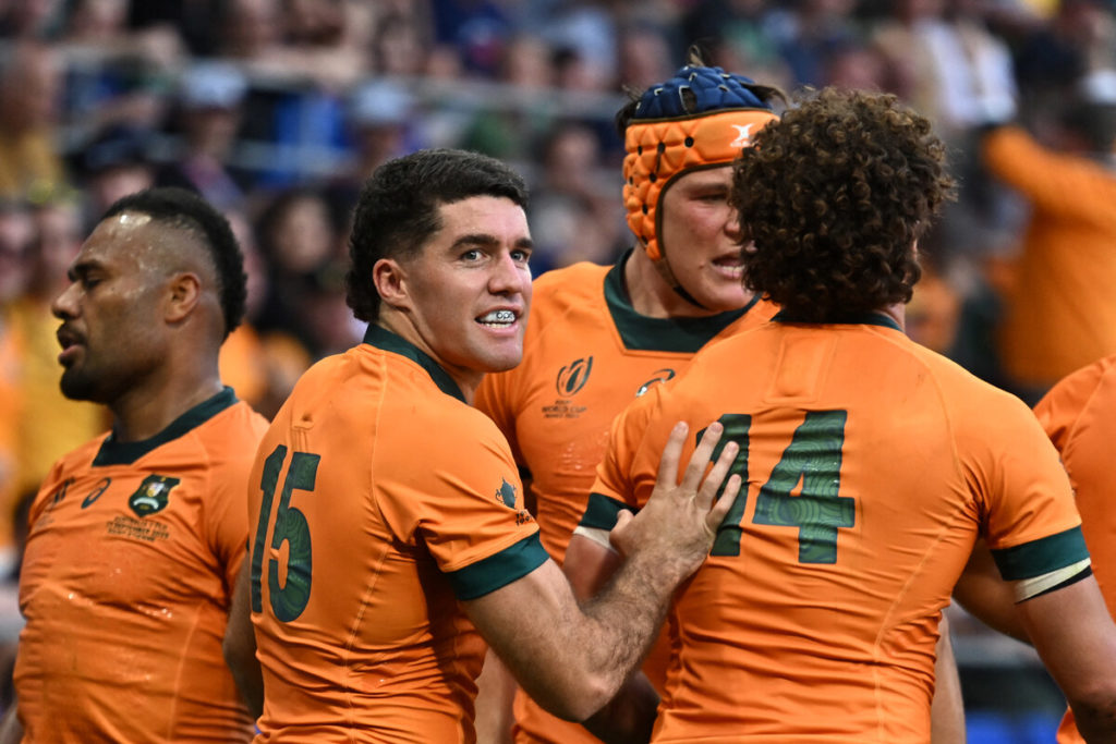 Australia's full-back Ben Donaldson (2L) congratulates Australia's right wing Mark Nawaqanitawase (R) after he scored Australia's first try during the France 2023 Rugby World Cup Pool C match between Australia and Fiji at Stade Geoffroy-Guichard in Saint-Etienne, south-eastern France on September 17, 2023.
