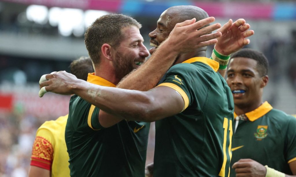 South Africa's wing Makazole Mapimpi (C) celebrates with South Africa's full-back Willie Le Roux (L) after scoring the team's tenth try during the France 2023 Rugby World Cup Pool B match between South Africa and Romania at Stade de Bordeaux in Bordeaux, south-western France on September 17, 2023.