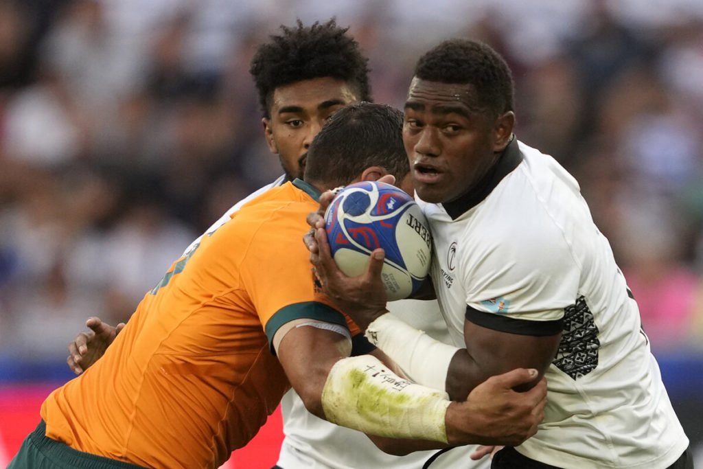 Fiji's inside centre Josua Tuisova (R) looks to offload the ball as he is tackled by Australia's lock Richie Arnold (L) during the France 2023 Rugby World Cup Pool C match between Australia and Fiji at Stade Geoffroy-Guichard in Saint-Etienne, south-eastern France on September 17, 2023.