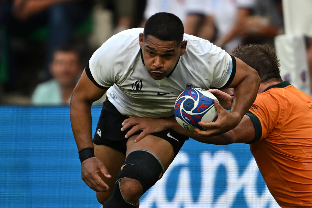 Fiji's hooker Sam Matavesi (C) runs with the ball as he is tackled by Australia's tighthead prop James Slipper (R) during the France 2023 Rugby World Cup Pool C match between Australia and Fiji at Stade Geoffroy-Guichard in Saint-Etienne, south-eastern France on September 17, 2023.