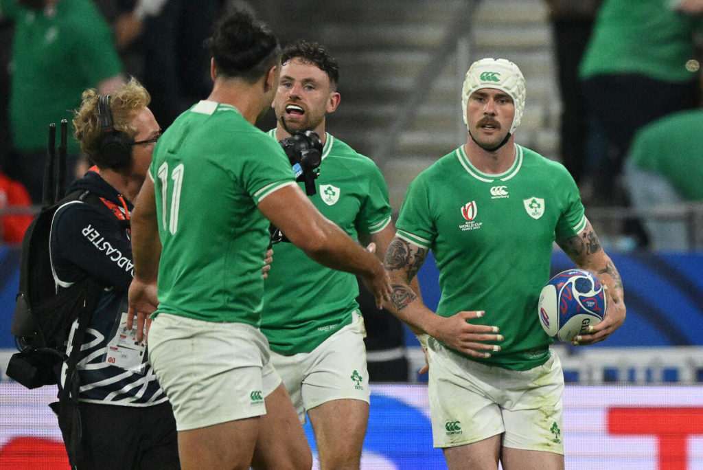 Ireland's right wing Mack Hansen (R) celebrates with teammates after scoring a try during the France 2023 Rugby World Cup Pool B match between South Africa and Ireland at the Stade de France in Saint-Denis, on the outskirts of Paris on September 23, 2023.