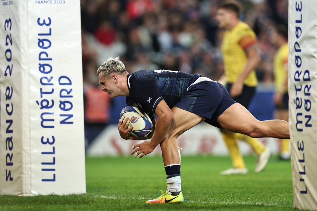 Scotland's wing Darcy Graham dives across the line to score a try during the France 2023 Rugby World Cup Pool B match between Scotland and Romania at Pierre-Mauroy stadium in Villeneuve-d'Ascq near Lille, northern France, on September 30, 2023.