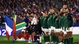 The Springboks line up for the anthem. France's players (L) and South Africa's players (R) stand for the national anthems ahead of the France 2023 Rugby World Cup quarter-final match between France and South Africa at the Stade de France in Saint-Denis, on the outskirts of Paris, on October 15, 2023.