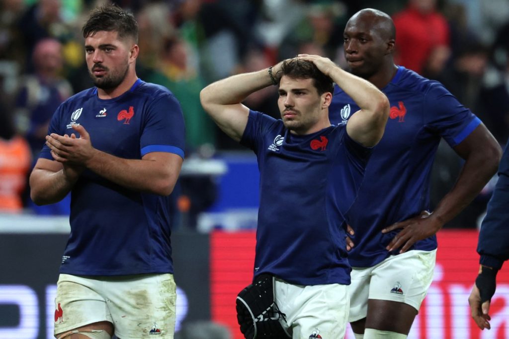 France's scrum-half and captain Antoine Dupont (C) holds his hands on his head as he walks off the field with France's players after loosing the France 2023 Rugby World Cup quarter-final match against South Africa at the Stade de France in Saint-Denis, on the outskirts of Paris, on October 15, 2023.
