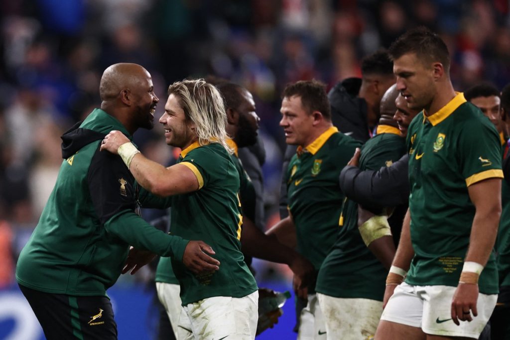 South Africa's scrum-half Faf de Klerk (C) South Africa's prop Ox Nche and South Africa's fly-half Handre Pollard (R) celebrate after victory in the France 2023 Rugby World Cup quarter-final match between France and South Africa at the Stade de France in Saint-Denis, on the outskirts of Paris, on October 15, 2023.
