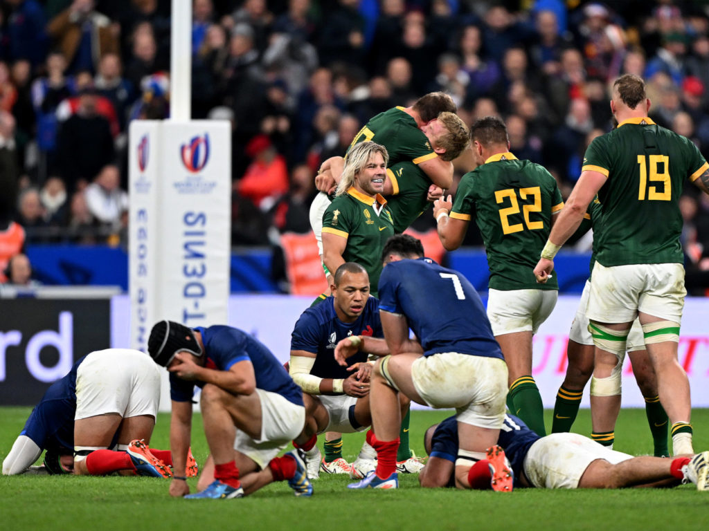 PARIS, FRANCE - OCTOBER 15: The players of France look dejected as the players of South Africa celebrate victory at full-time following the Rugby World Cup France 2023 Quarter Final match between France and South Africa at Stade de France on October 15, 2023 in Paris, France. (Photo by Mike Hewitt/Getty Images)