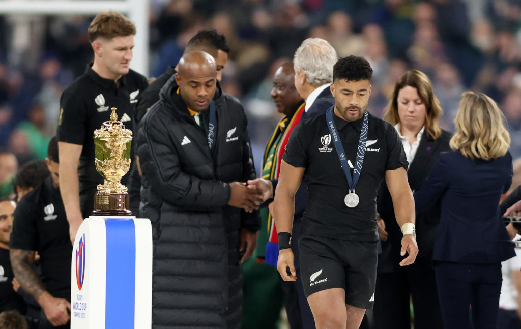 PARIS, FRANCE - OCTOBER 28: Richie Mo'unga of New Zealand looks dejected as they walk past the Webb Ellis Cup after the Rugby World Cup France 2023 Gold Final match between New Zealand and South Africa at Stade de France on October 28, 2023 in Paris, France.