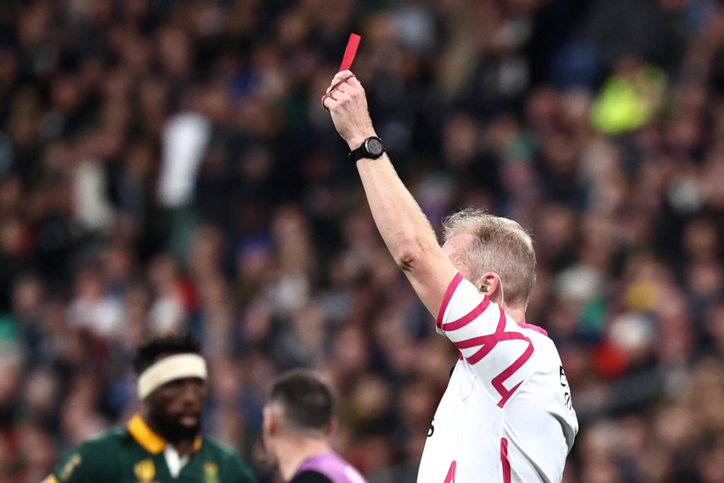 English referee Wayne Barnes shows a red card to New Zealand's openside flanker and captain Sam Cane (not seen) during the France 2023 Rugby World Cup Final match between New Zealand and South Africa at the Stade de France in Saint-Denis, on the outskirts of Paris, on October 28, 2023. (Photo by Anne-Christine POUJOULAT / AFP)