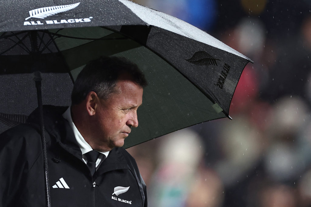 New Zealand's head coach Ian Foster holds an umbrella on the pitch as he looks on ahead of the France 2023 Rugby World Cup Final match between New Zealand and South Africa at the Stade de France in Saint-Denis, on the outskirts of Paris, on October 28, 2023. (Photo by FRANCK FIFE / AFP) / TECHNICAL REPEAT: This photo by FRANCK FIFE has been modified in AFP systems with a PIXEL CORRECTION: [CROP]. Please immediately replace the erroneous versions from all your online services and servers. If you have been authorized by AFP to distribute it to third parties, please ensure that the same actions are carried out by them. Failure to promptly comply with these instructions will entail liability on your part for any continued or post notification usage. Therefore we thank you very much for all your attention and prompt action. We are sorry for the inconvenience this notification may cause and remain at your disposal for any further information you may require.